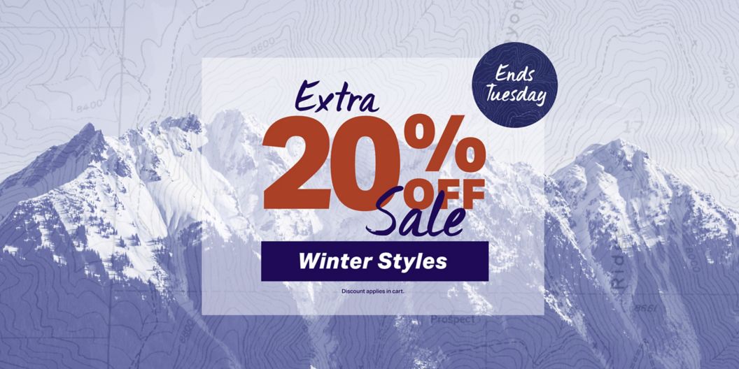 A snowy mountain landscape with a topo map overlay. A graphic text overlay reads “Ends Tuesday Extra 20% off Sale Winter Styles” with a disclaimer: “Discount applies in cart. Exclusions apply.”